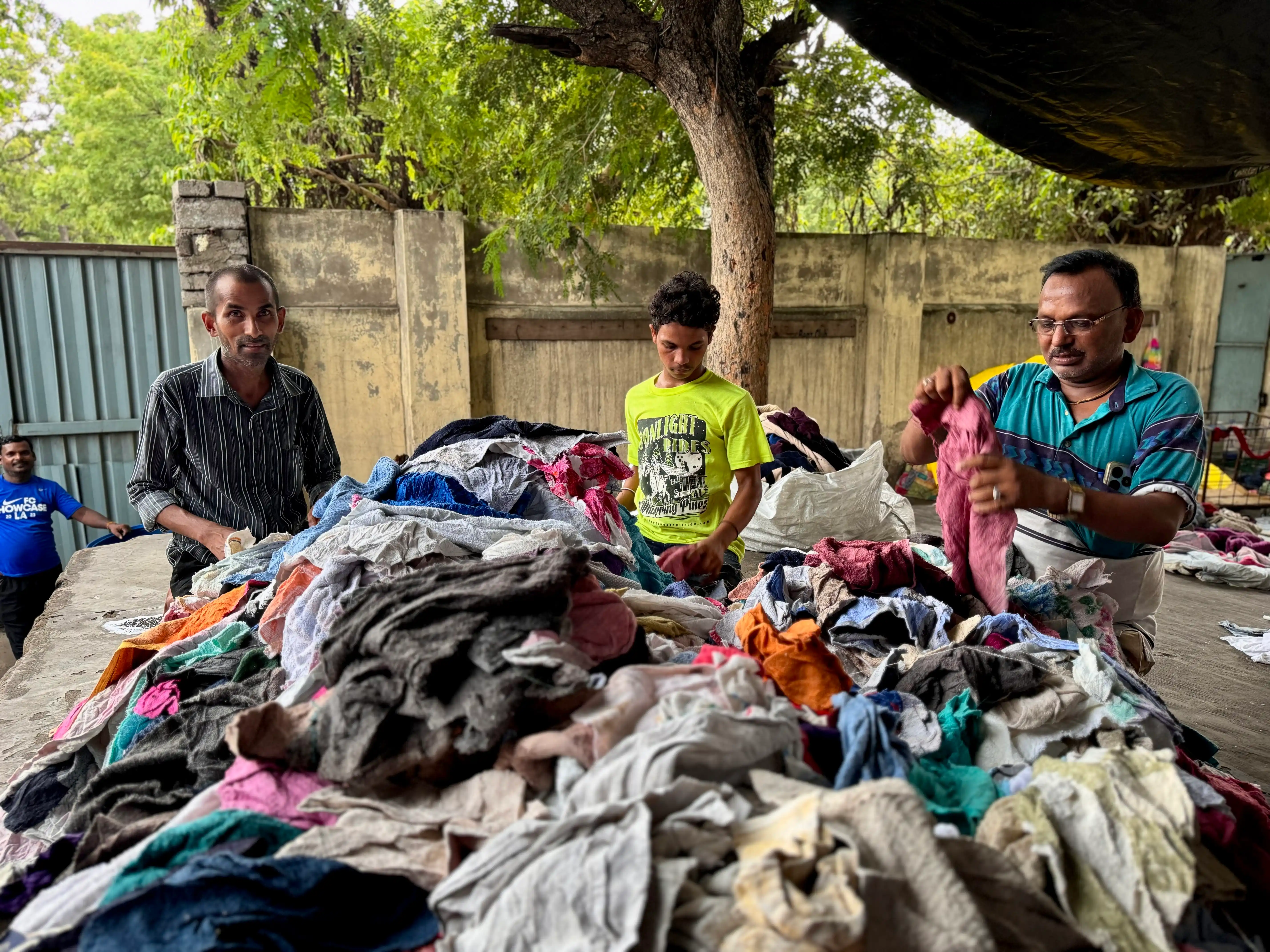 huge quantities Used clothing being inspected and sorted